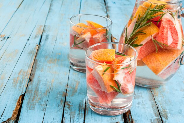 Verfrissende zomer detox cocktail van grapefruit en rozemarijn, op houten rustieke tafel, kopie ruimte