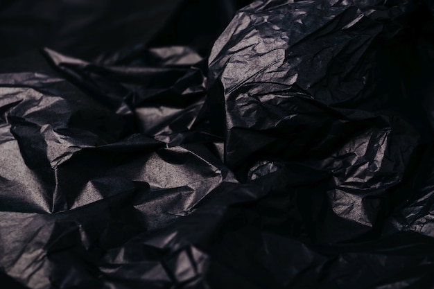 Verfrommeld donker zwart papier textuur abstracte achtergrond