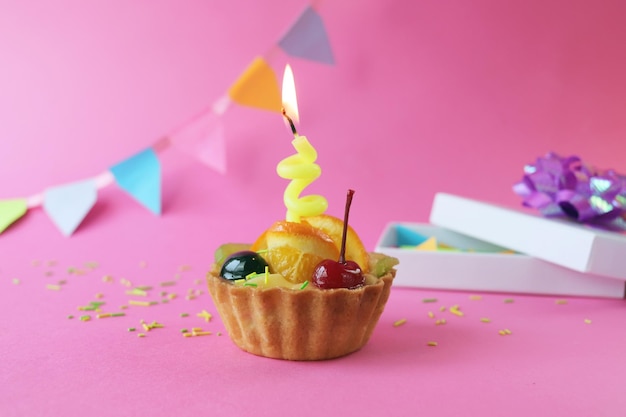 Verjaardag cupcake versierd met fruitgelei en een brandende kaars vakantiedecoraties