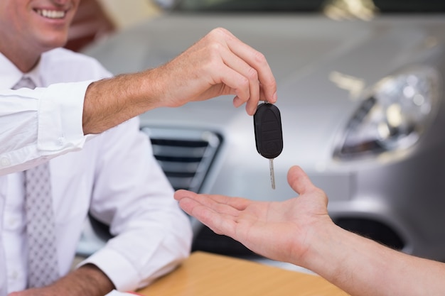 Verkoper die de sleutels van een klantauto geven