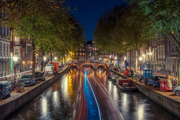 Verlichte brug over een kanaal in de stad's nachts