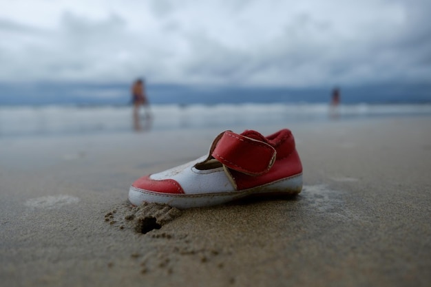 Verloren kinderschoen op strandzand