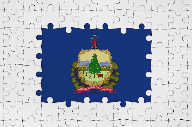 Photo vermont us state flag in frame of white puzzle pieces with missing central part