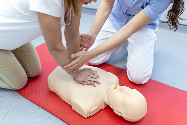 Verpleegkundigen leren hoe ze de patiënt kunnen redden tijdens een reanimatietraining met reanimatiepop Closedup Soft focus