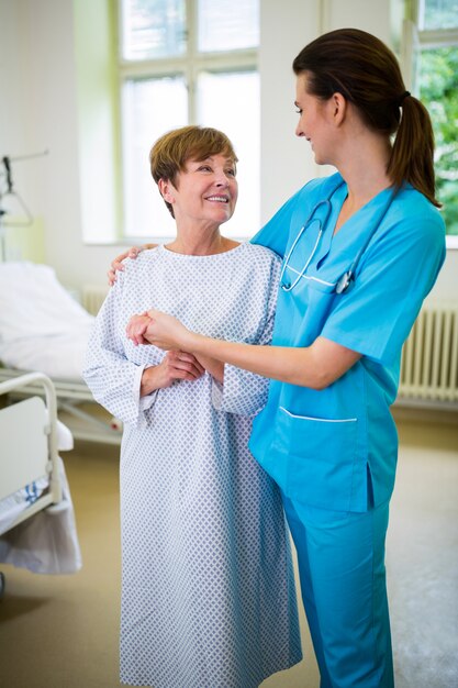 Foto verpleegster die een patiënt troosten in de afdeling van het ziekenhuis