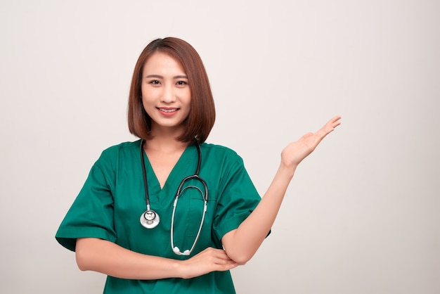 Verpleegster in uniform met stethoscoop op wit wordt geïsoleerd