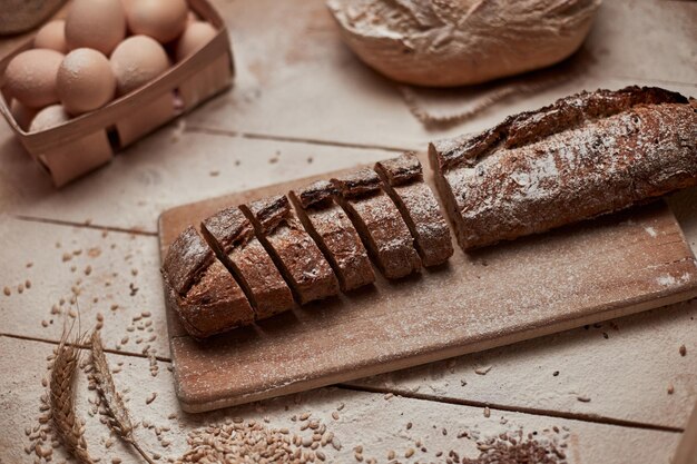 Vers gebakken brood Bovenaanzicht van gesneden volkoren brood op donkere ructische houten close-up als achtergrond