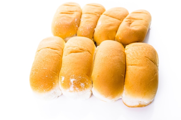 Vers gebakken hotdogbroodjes op een witte achtergrond.