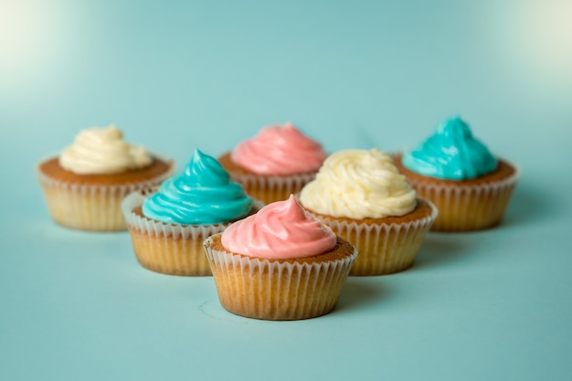 Vers gebakken kleurrijke cupcakes op blauwe achtergrond