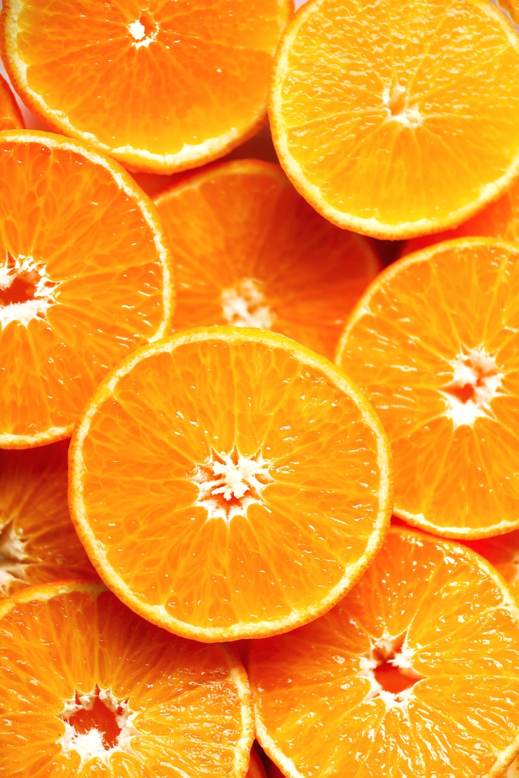 Foto vers gesneden oranje fruittextuur. macro, bovenaanzicht, kopie ruimte. voedsel. sappige sinaasappelen