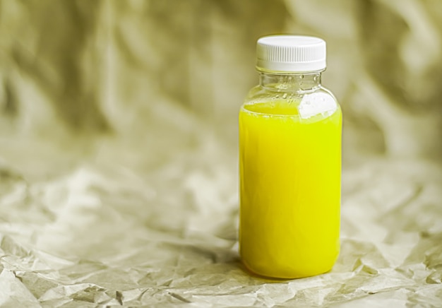 Vers limoen- of citroensap in milieuvriendelijke recyclebare plastic fles en verpakking van gezond drankje en voedselproductconcept