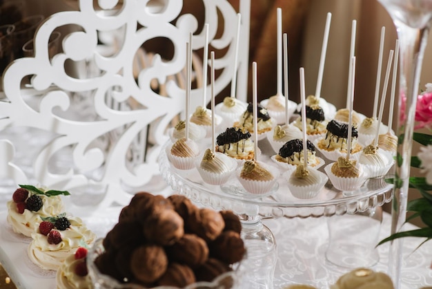 Verscheidenheid aan snoepjes, taarten en cupcakes bij de candybar