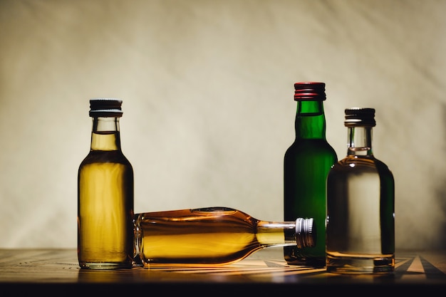 Verschillende alcoholflessen staan op tafel aan een lamp