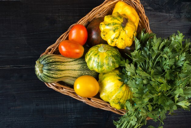 Verschillende herfst groenten in een mand op een houten tafel