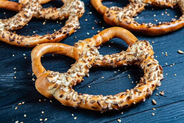 Verschillende soorten gebakken bagels met zaden op een zwarte achtergrond