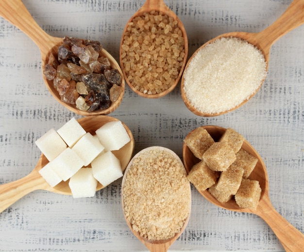 Verschillende soorten suiker in lepels op tafel close-up