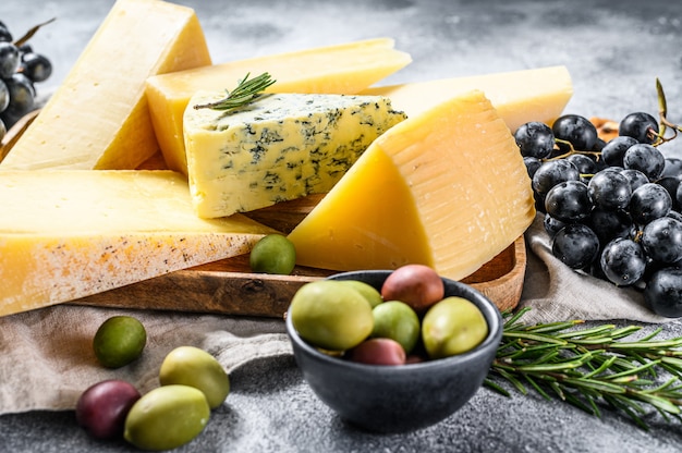 Verschillende stukken kaas met notenolijven en druiven. Diverse heerlijke snacks. Bovenaanzicht