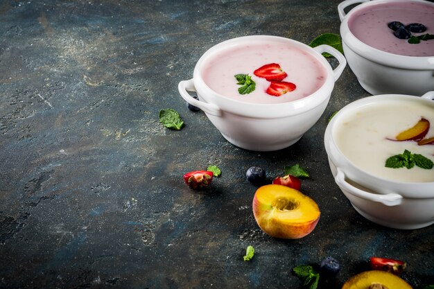 Verschillende zoete romige fruit- en bessensoepen