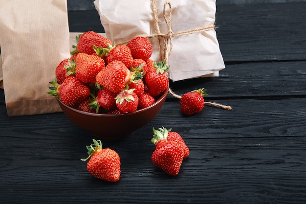 Verse aardbeien in een plaat op een donkere houten