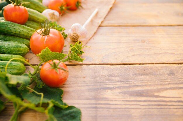 Verse groenten op een houten achtergrond Lege ruimte voor de tekst Komkommers, tomaten, knoflook, dille Bovenaanzicht