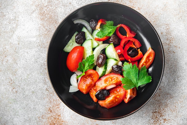 Verse groentesalade tomaat komkommer peper ui zwarte olijven ontpit gezonde maaltijd eten snack