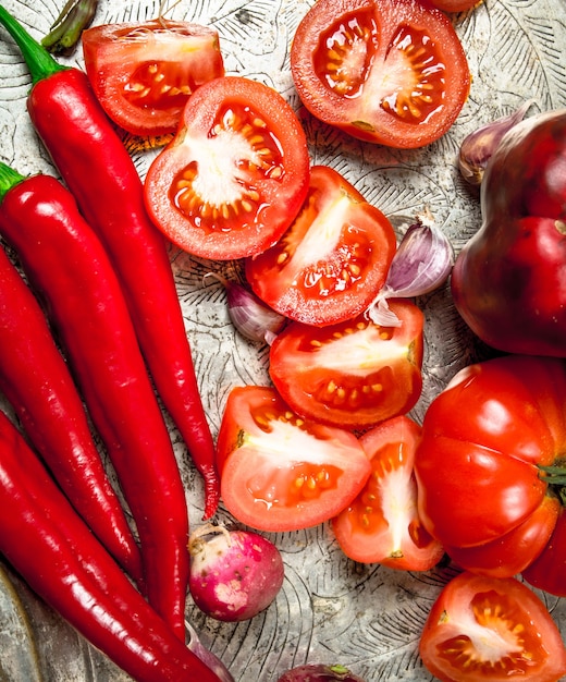 Verse hete Spaanse peperpeper, tomaten en paprika op een staalblad