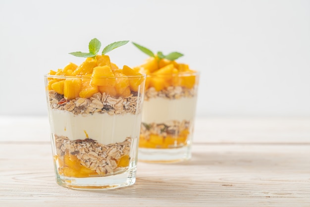 Verse mangoyoghurt met granola in glas