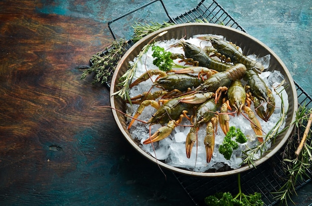 Verse rivierkreeften in een kom met ijs op een stenen keukentafel Bovenaanzicht Plat leggen