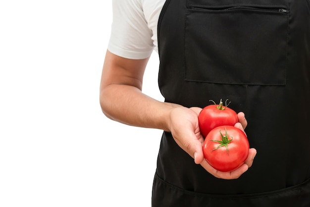 Verse rode tomaten in de hand van de kok op een witte geïsoleerde achtergrond biologische producten