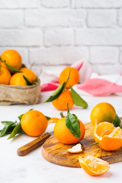 Verse, sappige biologische oranje mandarijnen mandarijnen met groene bladeren op een keukentafel Gezond vitamine eten concept Kopieer ruimte achtergrond