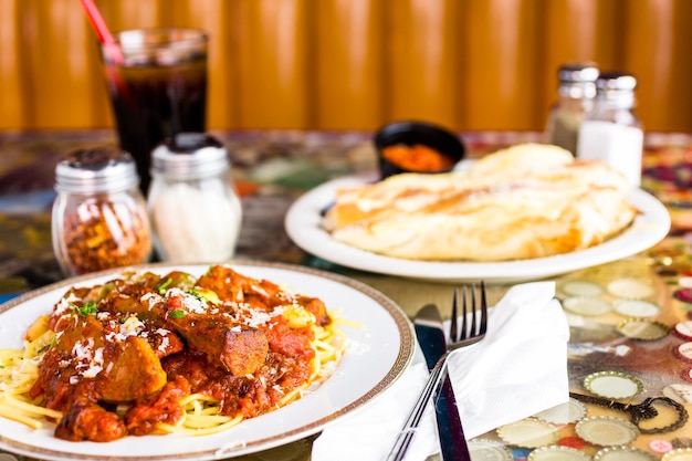 Verse spaghetti met worst, paprika en uien in Italiaans restaurant.