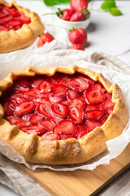 Verse zelfgemaakte galettes met aardbeien op witte marmeren achtergrond. Selectieve aandacht.