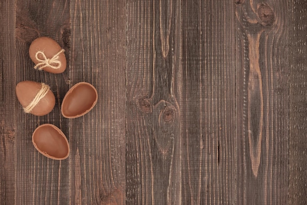 Versierd met jute touw chocolade-eieren op de bruine houten achtergrond Paasverrassing