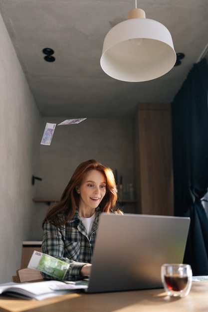 Foto verticaal portret van een succesvolle jonge zakenvrouw met geld dollar regen vallen tijdens het werken