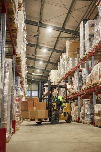 Vertical background image of warehouse interior with forklift