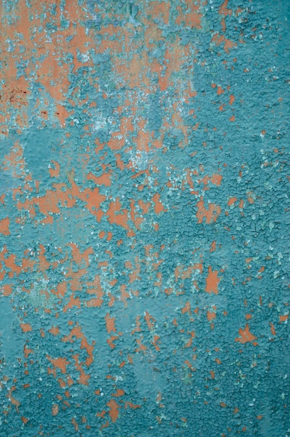 Vertical background old cracked paint on fence primer orange peeling paint green
