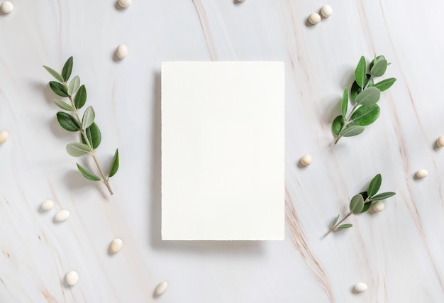 Vertical card on a marble table decorated with eucalyptus branches top view Wedding mockup