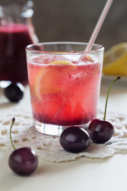 Vertical close up photo of homemade cherry lemonade in glasses