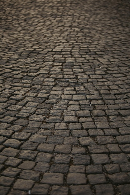 Vertical closeup of the old cobblestone pavement background