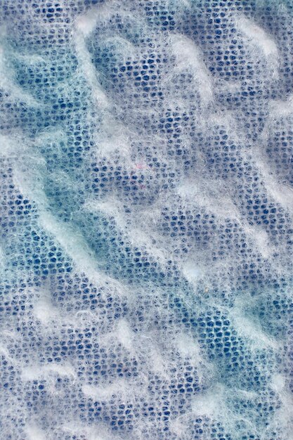 Vertical closeup shot of a fuzzy blue surface