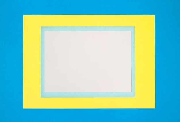 Photo vertical composition with white, blue and yellow sheets