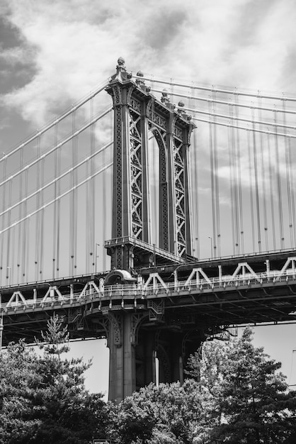 Vertical grayscale shot of the Brooklyn Bridge in New York City