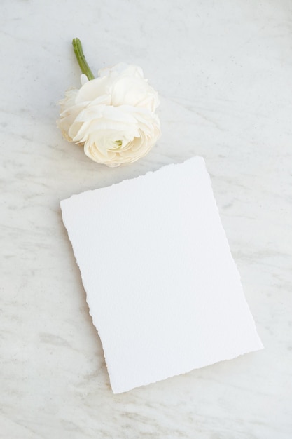 Vertical handmade paper card mockup for wedding invitations on a marble background