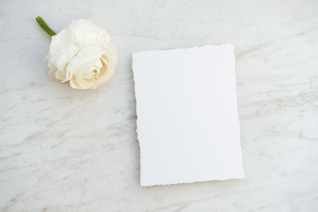 Vertical handmade paper card mockup for wedding invitations on a marble background