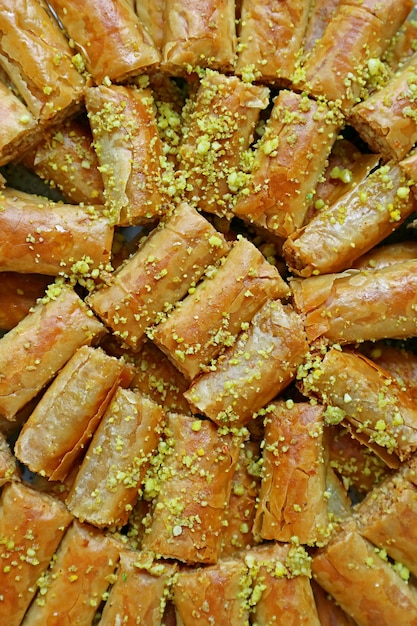 Vertical Image of Delectable Baklava Pastries Topped with Chopped Pistachio Nuts