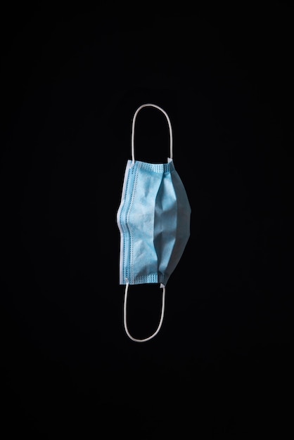 vertical image of a medical mask that falls