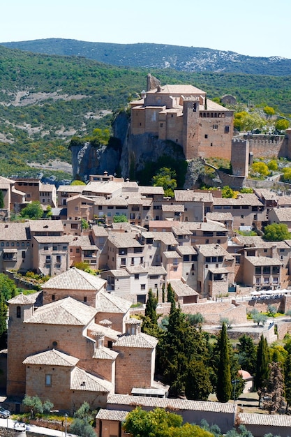 Vertical panoramic photo of medieval village Alquezar downtown at daytime Skyline layered landscape Sierra de Guara Natural Park Comarca Somontano de Barbastro Huesca Aragon Spain