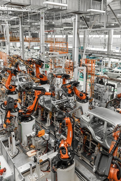 Foto foto verticale della linea di produzione di automobili moderno impianto di assemblaggio di automobili industria automobilistica interno di una fabbrica high-tech di produzione moderna