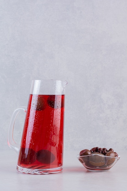 Vertical photo of chocolate candies with ice teas on grey