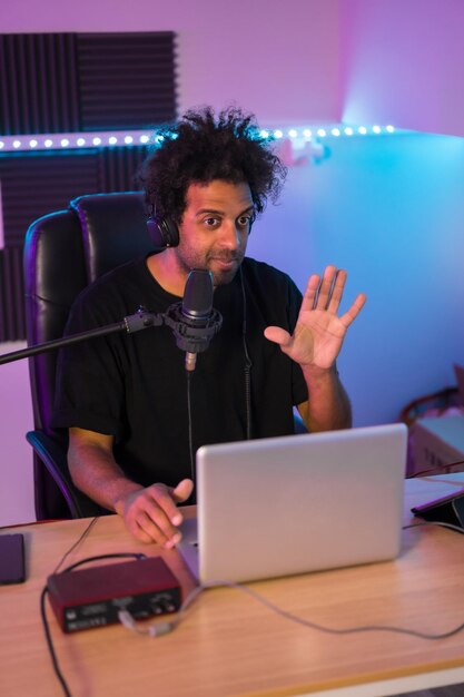 Vertical photo of a content creator during a life video tutorial in studio